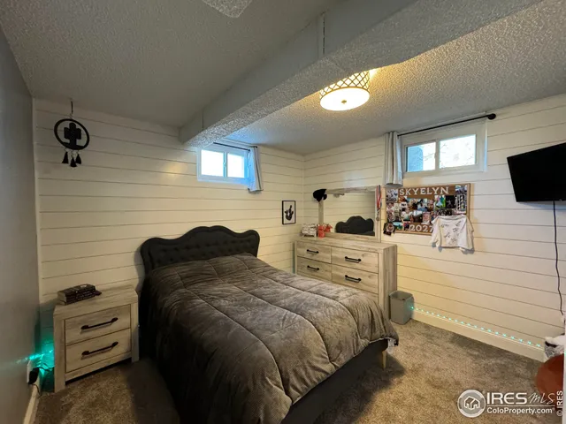 a bedroom with a bed and a television