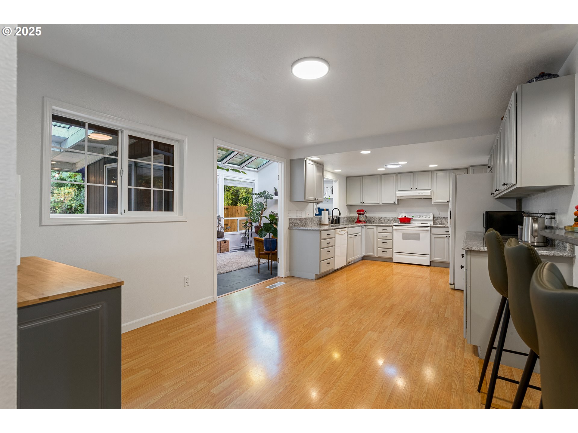 8405 Southwest Lori Way Beaverton, OR 97007 - Photo 14 of 48 a kitchen with stainless steel appliances granite countertop a refrigerator sink and cabinets