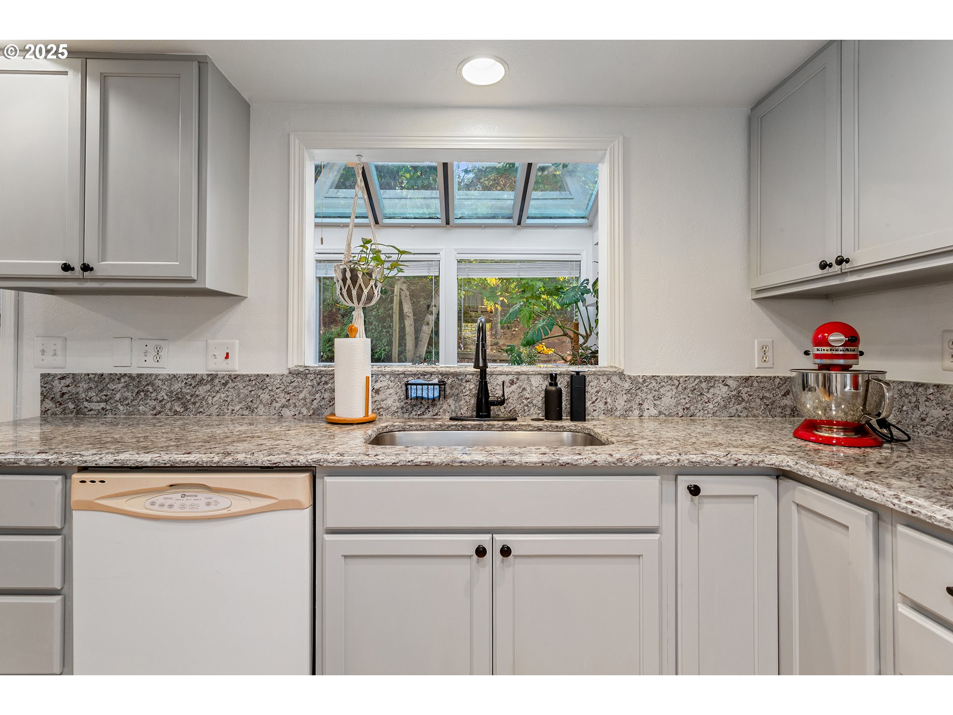 8405 Southwest Lori Way Beaverton, OR 97007 - Photo 16 of 48 a kitchen with stainless steel appliances granite countertop a sink stove and cabinets
