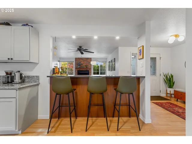 a kitchen with stainless steel appliances kitchen island granite countertop a table and chairs