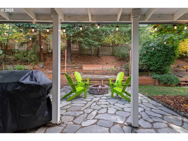 a view of a porch with furniture and garden