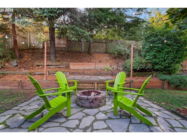 a view of a chairs and table in the backyard