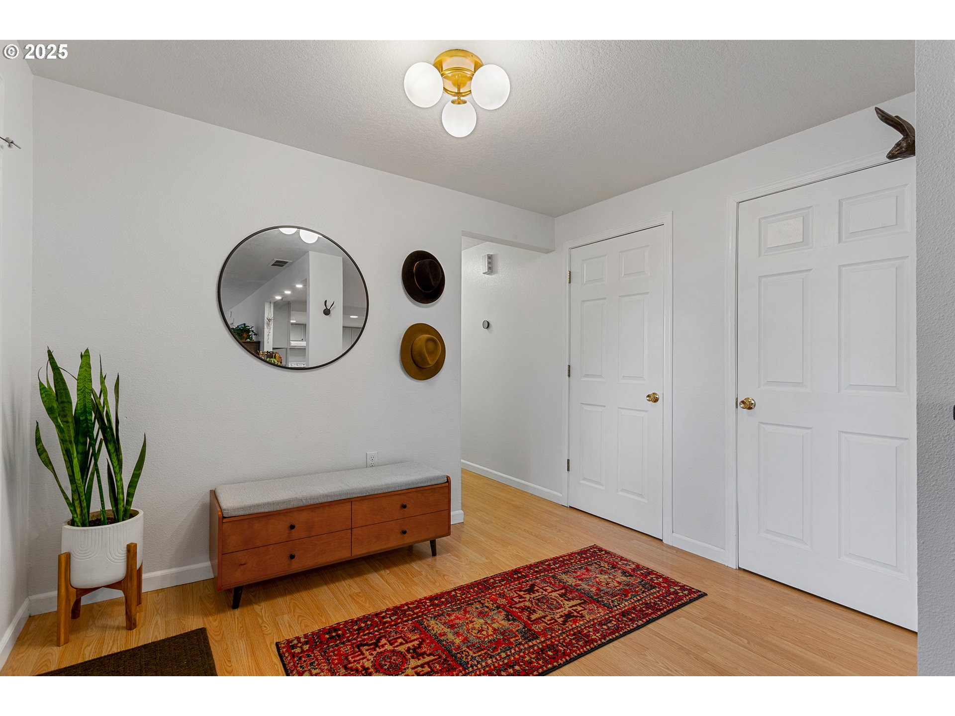 8405 Southwest Lori Way Beaverton, OR 97007 - Photo 6 of 48 a picture of a room with a clock and a potted plant