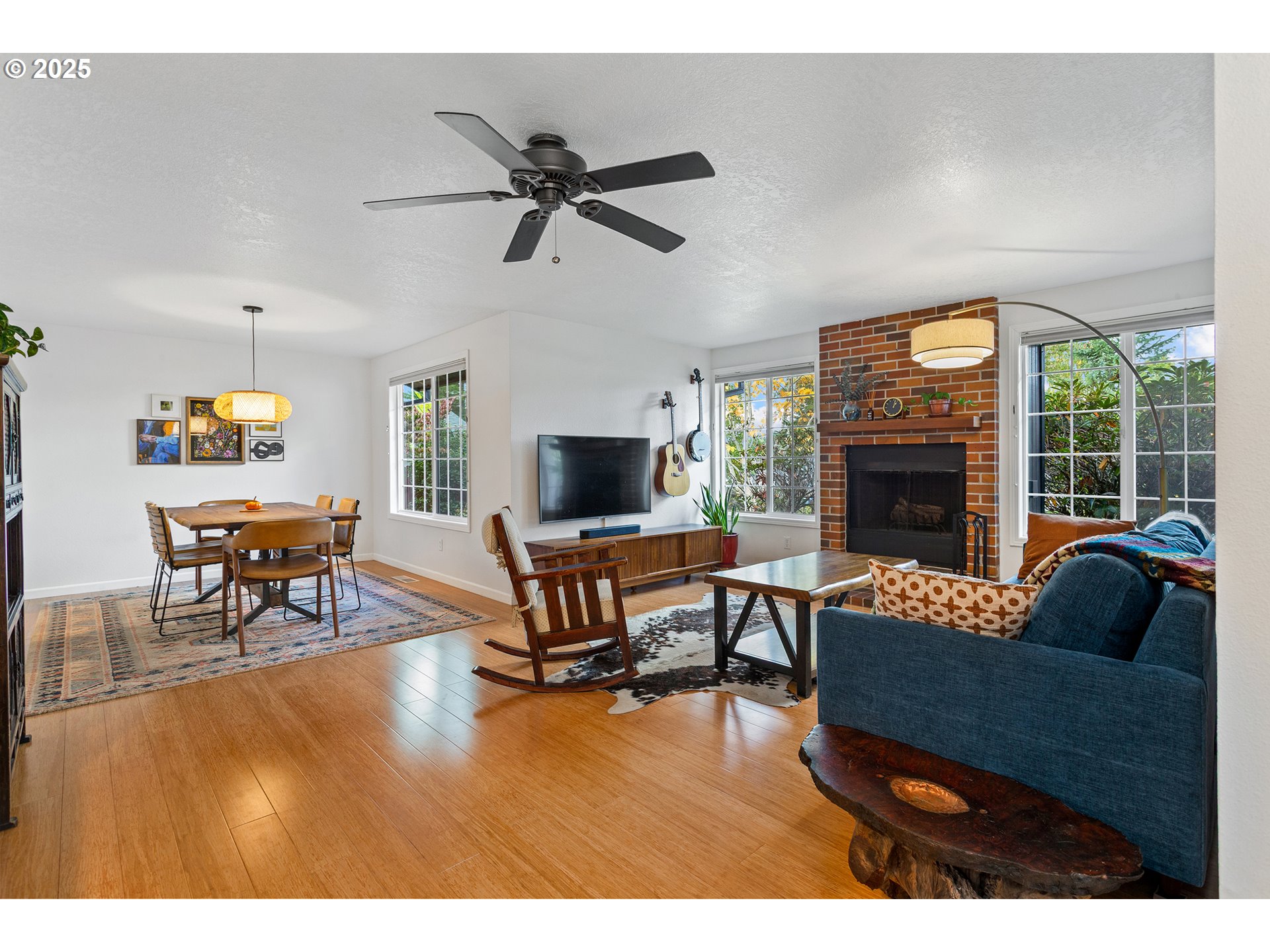 8405 Southwest Lori Way Beaverton, OR 97007 - Photo 8 of 48 a living room with furniture a fireplace and a flat screen tv