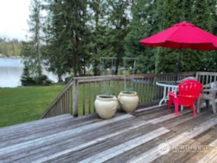 427 West Shore Loop Road Snohomish, WA 98290 - Photo 4 of 5 a view of a wooden floor with a table and chairs under an umbrella