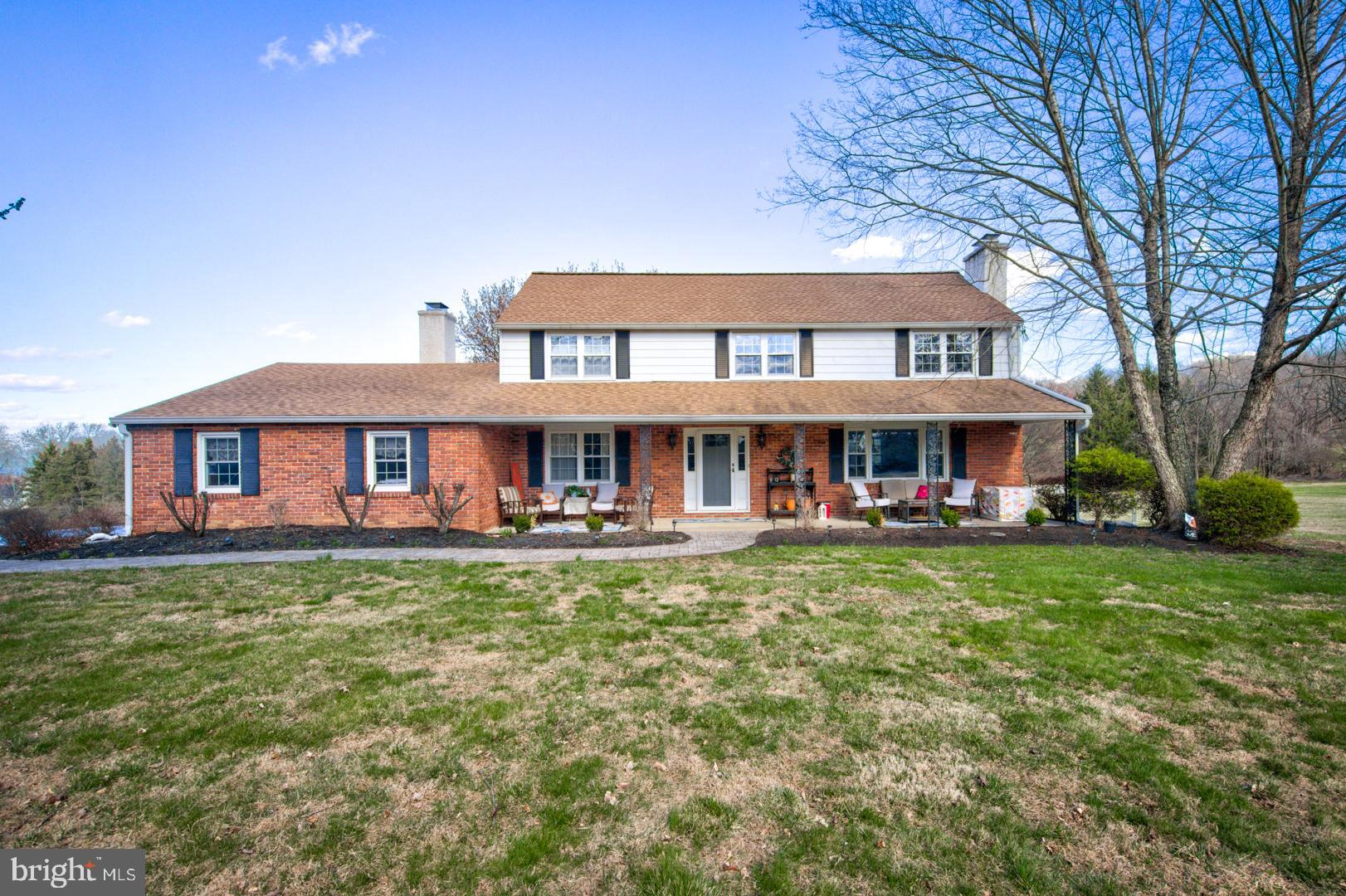 a front view of a house with yard porch and furniture
