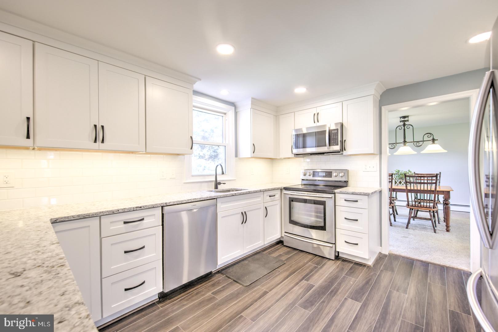 115 Diamond Rock Road Phoenixville, PA 19460 - Photo 12 of 33 a kitchen with granite countertop white cabinets and white appliances
