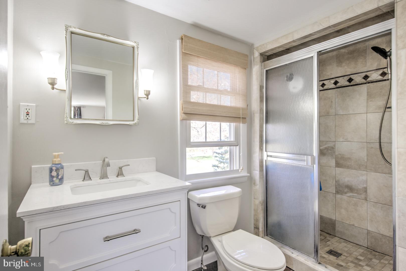 115 Diamond Rock Road Phoenixville, PA 19460 - Photo 21 of 33 a bathroom with a toilet sink vanity and windows