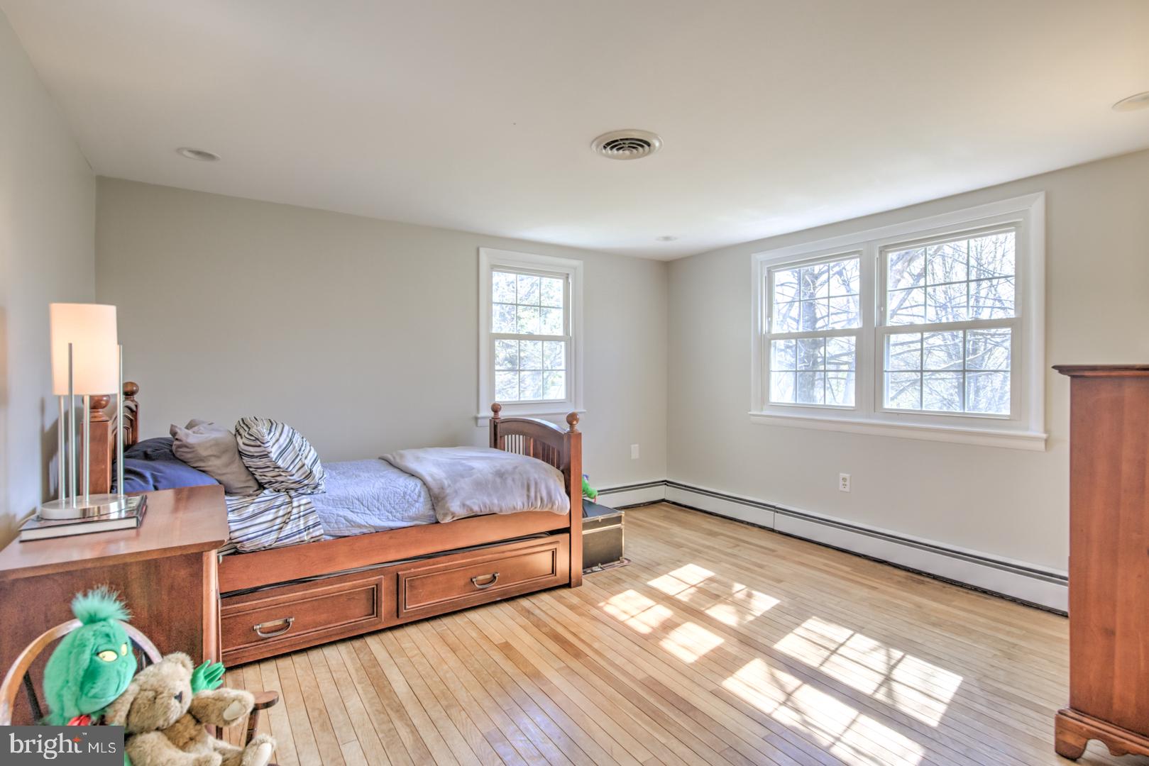 115 Diamond Rock Road Phoenixville, PA 19460 - Photo 26 of 33 a bedroom with a bed and wooden floor