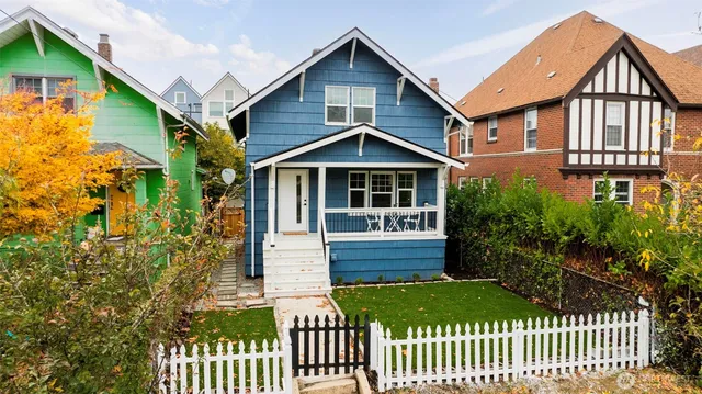 a front view of a house with a garden