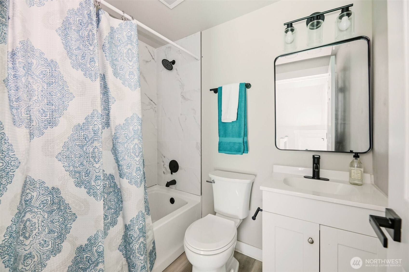 2813 15th Avenue South Seattle, WA 98144 - Photo 17 of 37 a bathroom with a toilet sink vanity tub and mirror