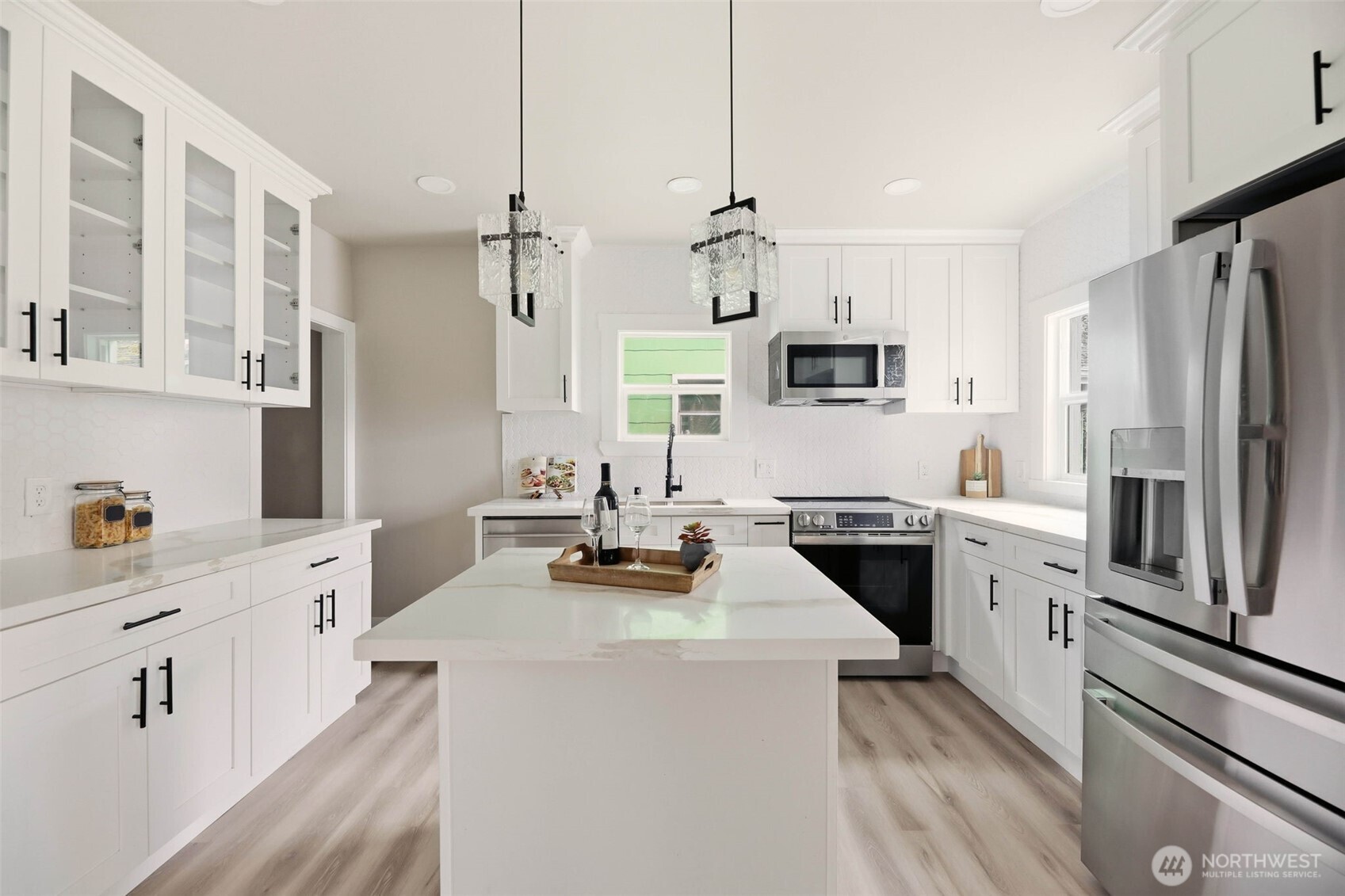 2813 15th Avenue South Seattle, WA 98144 - Photo 9 of 37 a kitchen with white cabinets and stainless steel appliances