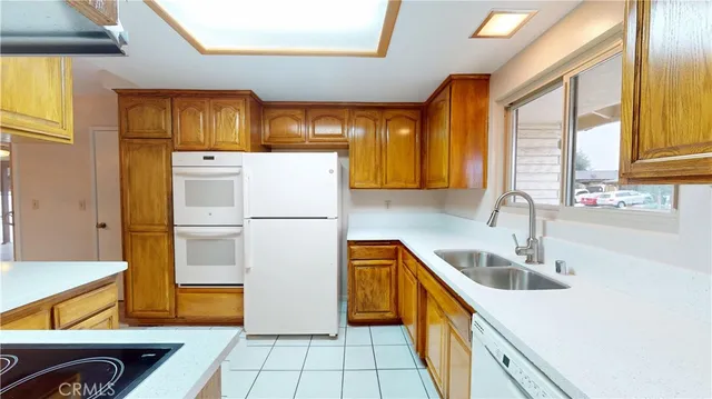 a kitchen with a sink a refrigerator and cabinets