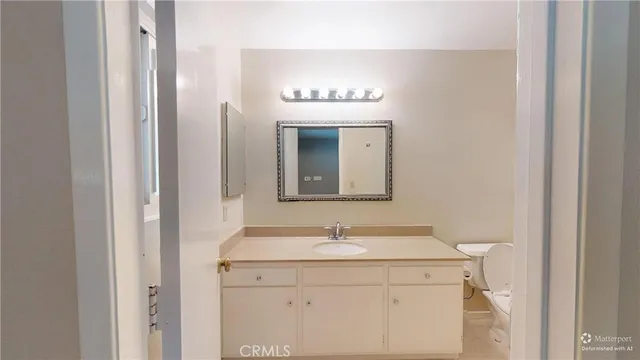a white toilet sitting next to a bathroom sink