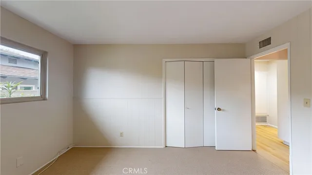 a bathroom with a granite countertop double vanity sink and a mirror