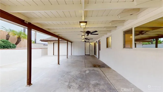 a view of a house with a big yard and large trees