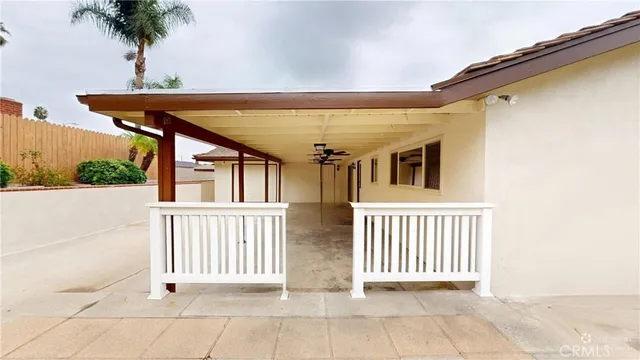 an aerial view of a house with a yard and large trees