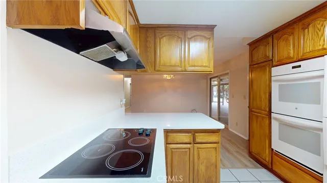 a kitchen with a refrigerator and cabinets