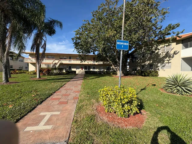 an aerial view of a swimming pool a yard and lake view