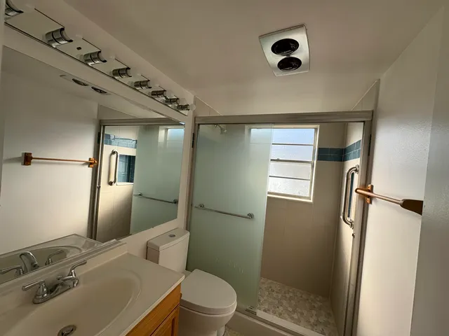 a bathroom with a sink toilet and shower
