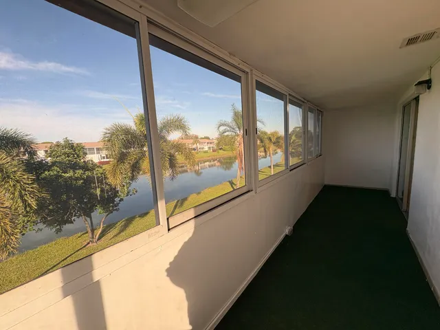 a view of a balcony with wooden floor and outdoor space