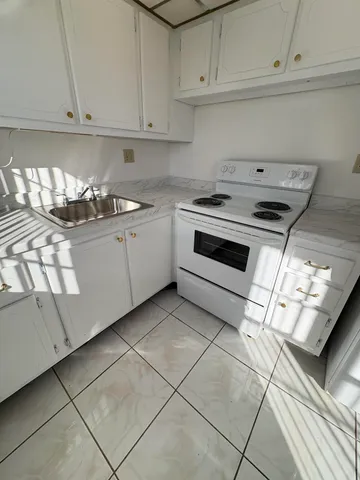 a kitchen with cabinets and appliances