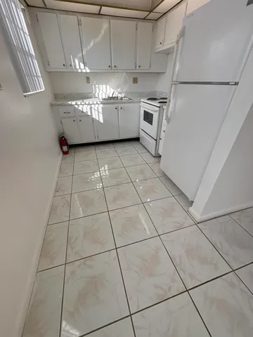 a kitchen with cabinets and white appliances