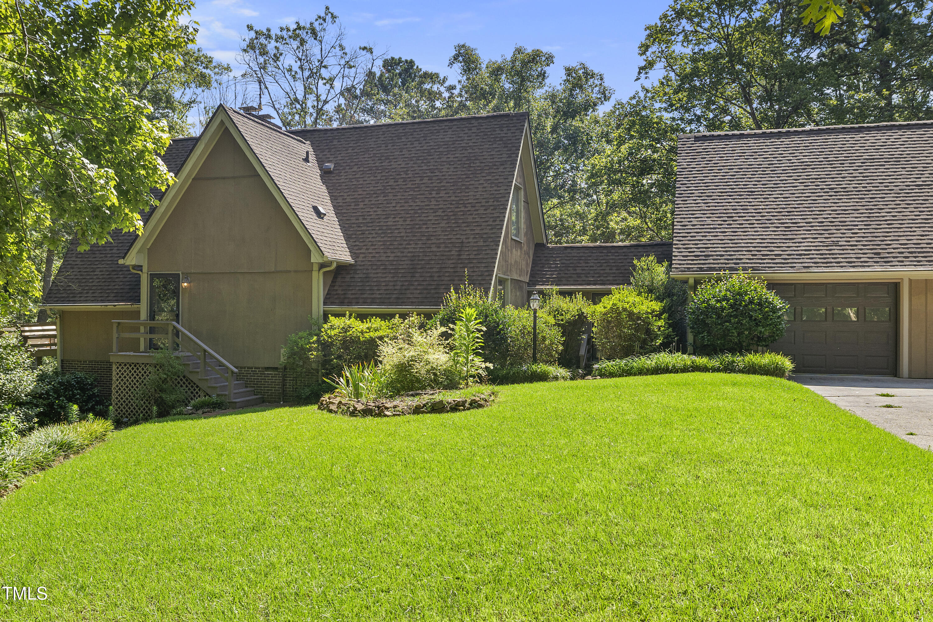 73 Hilltop Road Sanford, NC 27330 - Photo 8 of 54 a view of backyard with potted plants and a large tree