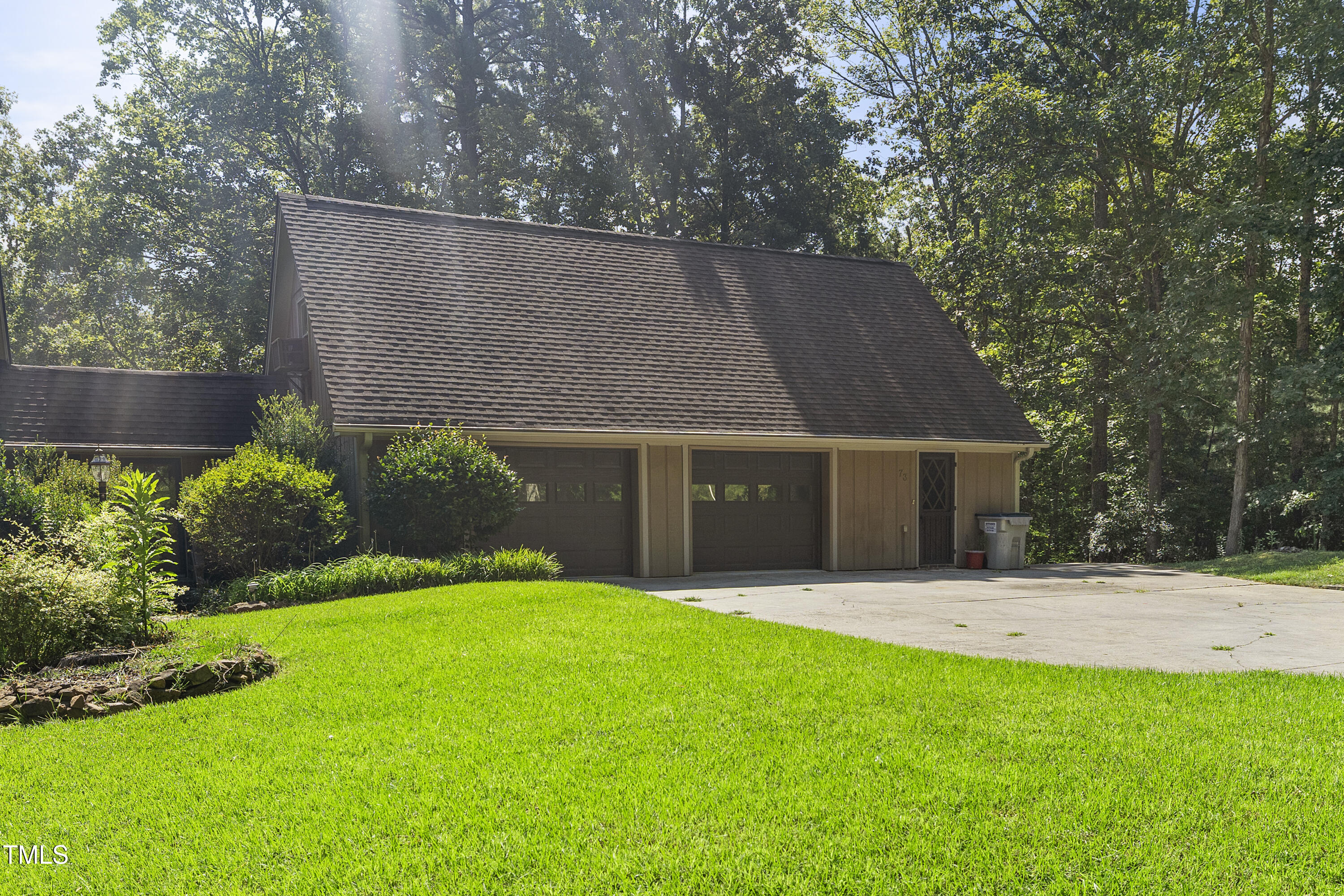 73 Hilltop Road Sanford, NC 27330 - Photo 2 of 54 a front view of a house with a yard and trees