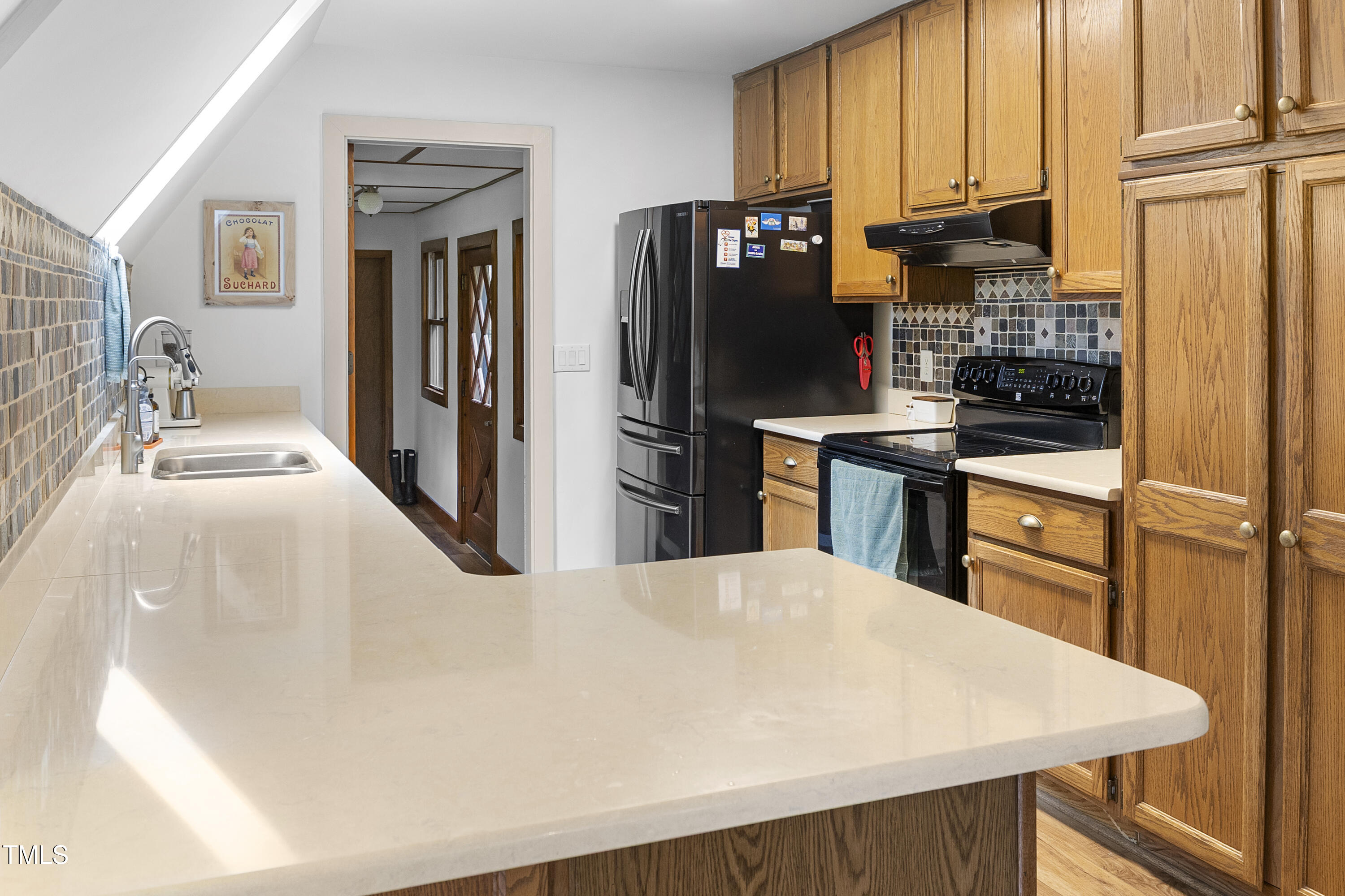 73 Hilltop Road Sanford, NC 27330 - Photo 28 of 54 a kitchen with stainless steel appliances a stove refrigerator sink and cabinets