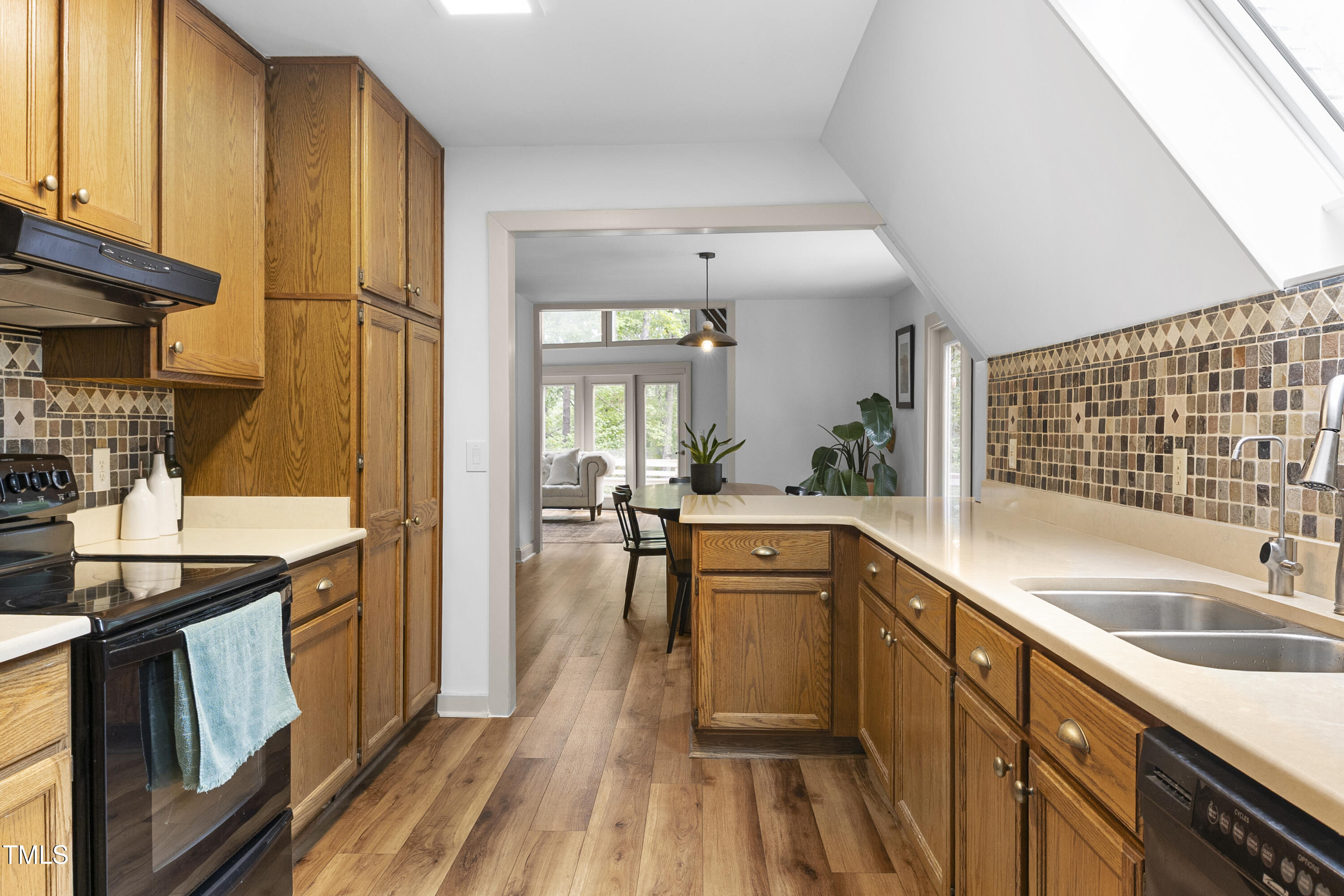 73 Hilltop Road Sanford, NC 27330 - Photo 30 of 54 a kitchen with stainless steel appliances granite countertop a sink and wooden cabinets