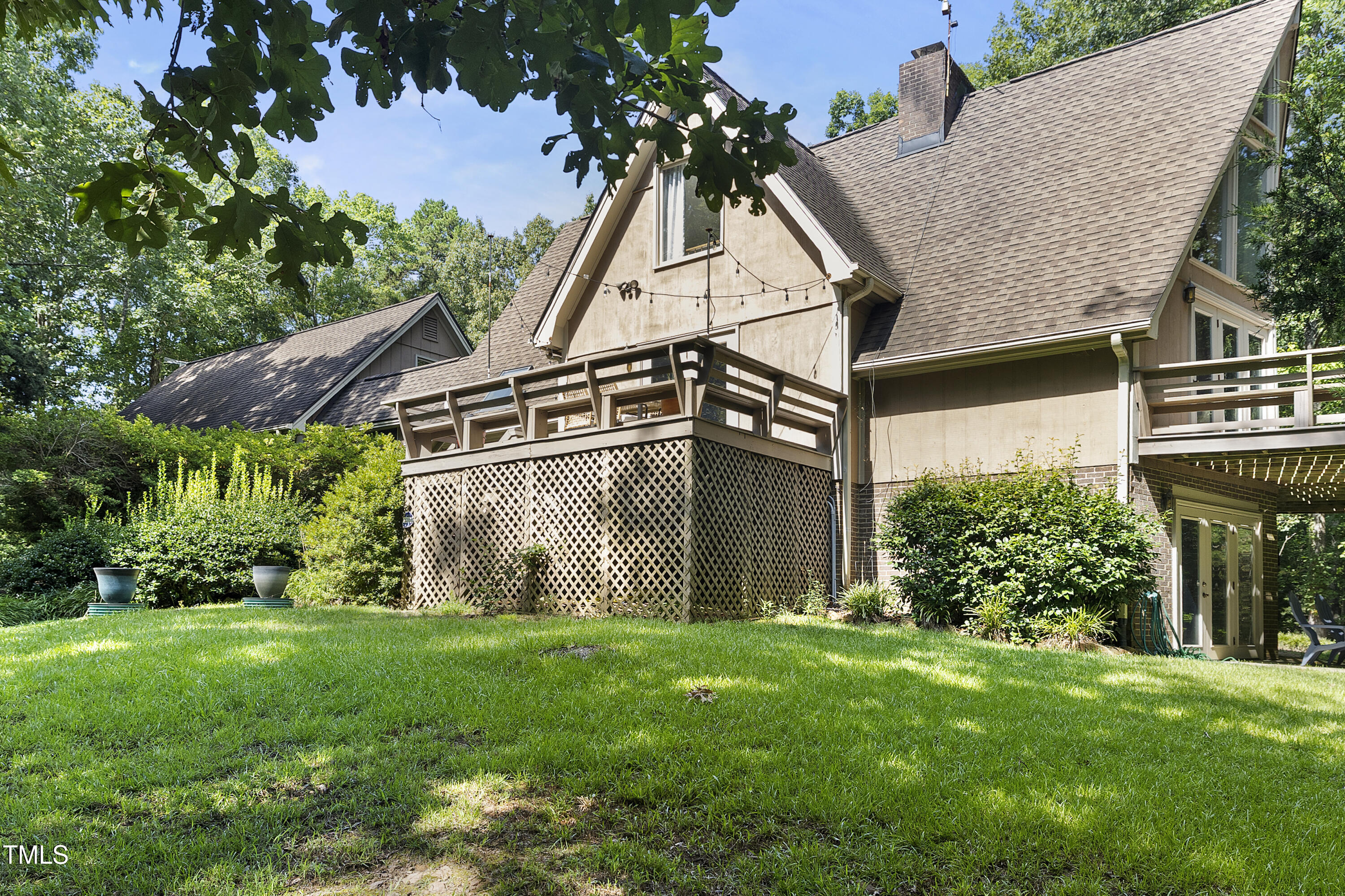 73 Hilltop Road Sanford, NC 27330 - Photo 3 of 54 a view of a house with brick walls and a yard with plants
