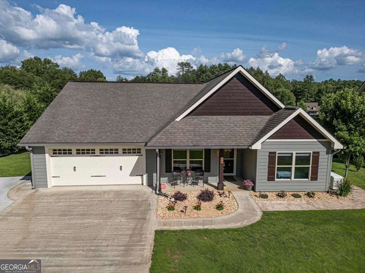 97 Lindsey Lane, Unit 17 Blue Ridge, GA 30513 - Photo 1 of 1 a front view of a house with garden