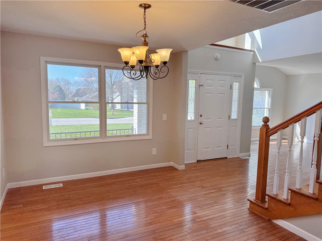 1118 Wedgewood Court Decatur, IL 62526 - Photo 7 of 22 a view of an empty room with wooden floor and a window