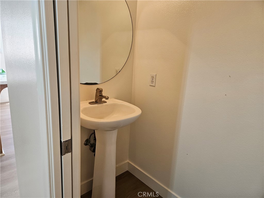 8598 Belmont Street Cypress, CA 90630 - Photo 12 of 23 a bathroom with a sink and a mirror