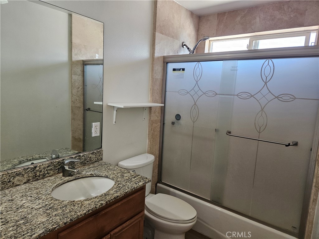 8598 Belmont Street Cypress, CA 90630 - Photo 17 of 23 a bathroom with a granite countertop sink toilet and shower