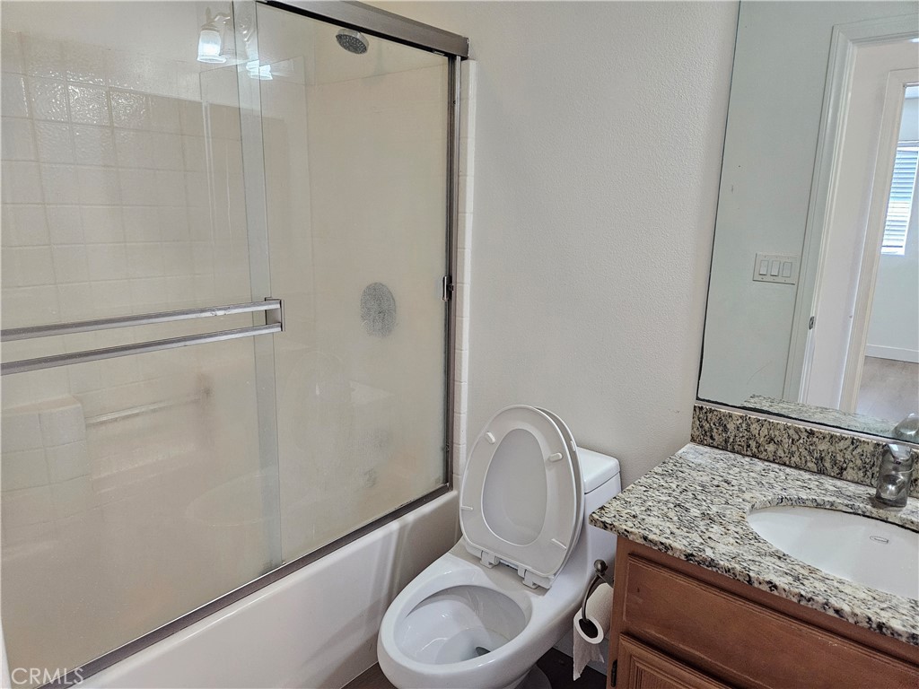 8598 Belmont Street Cypress, CA 90630 - Photo 20 of 23 a bathroom with a granite countertop sink toilet and shower