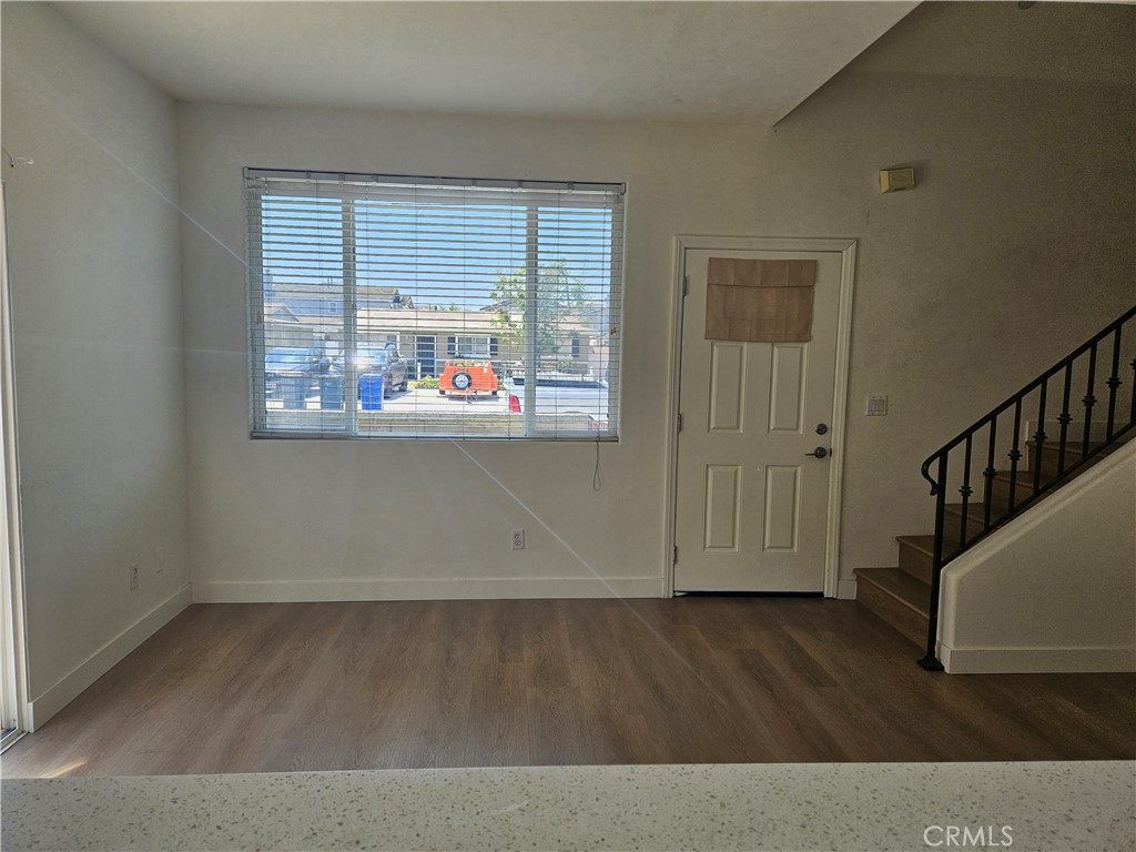 8598 Belmont Street Cypress, CA 90630 - Photo 4 of 23 an empty room with wooden floor and windows