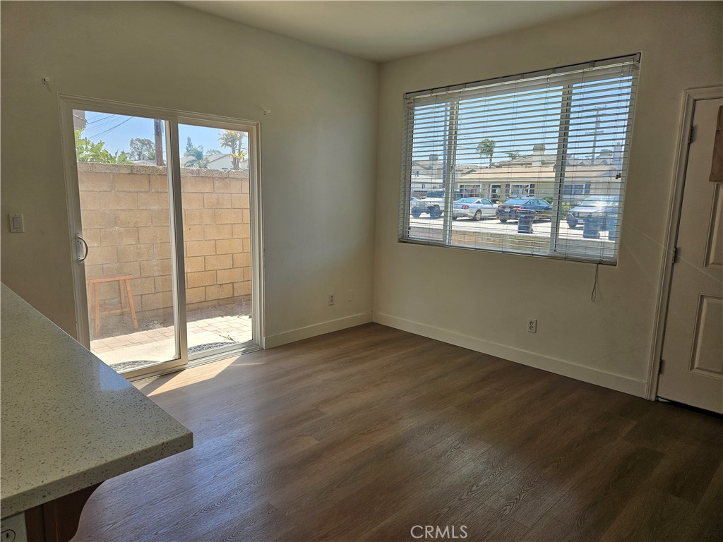 8598 Belmont Street Cypress, CA 90630 - Photo 5 of 23 an empty room with wooden floor and windows