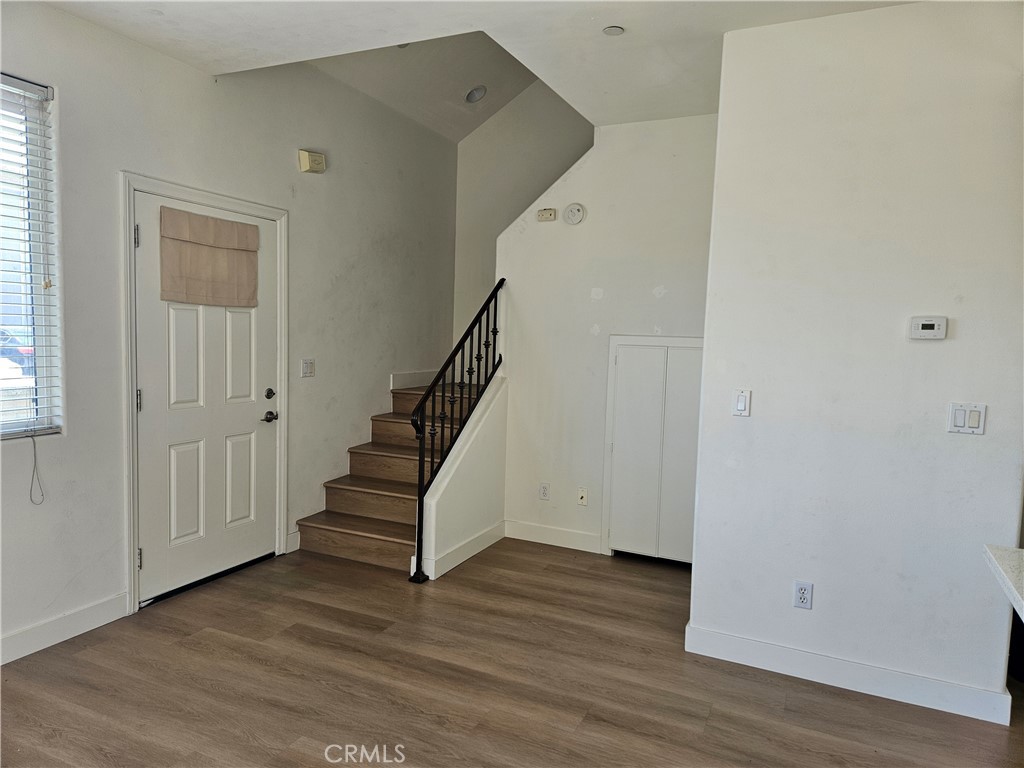 8598 Belmont Street Cypress, CA 90630 - Photo 6 of 23 an empty room with wooden floor and windows