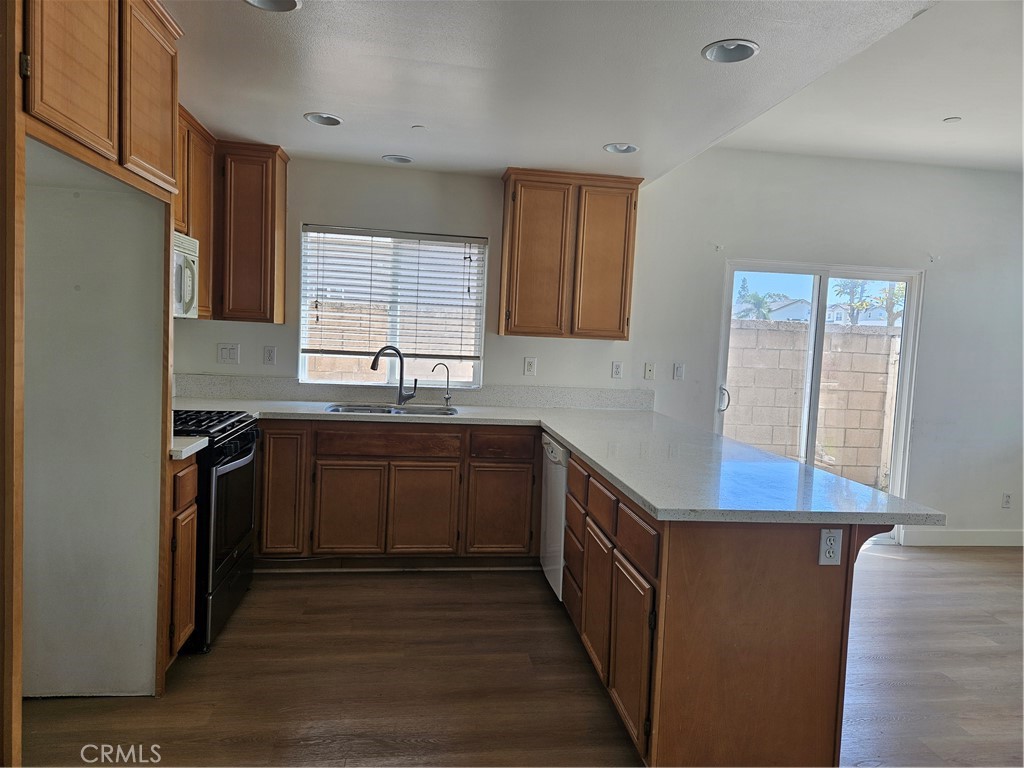 8598 Belmont Street Cypress, CA 90630 - Photo 9 of 23 a kitchen with stainless steel appliances granite countertop a sink stove and refrigerator