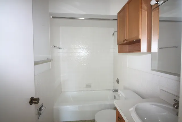 a bathroom with a toilet and shower