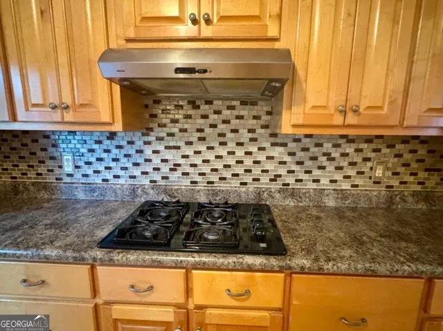 a close view of a stove top oven sitting inside of a kitchen