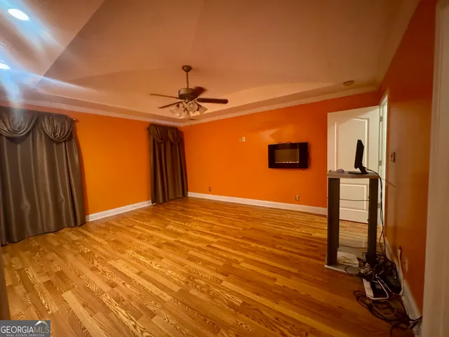 a view of a room with wooden floor