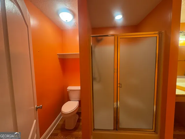 a bathroom with a toilet and a shower