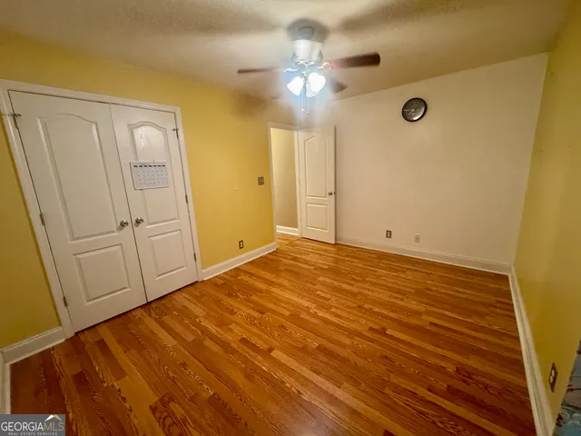 a view of a livingroom with wooden floor and closet area