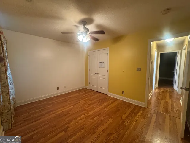 a view of an empty room with wooden floor