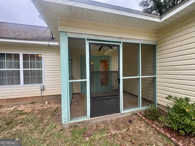 a view of a hallway with a chandelier fan and closet area