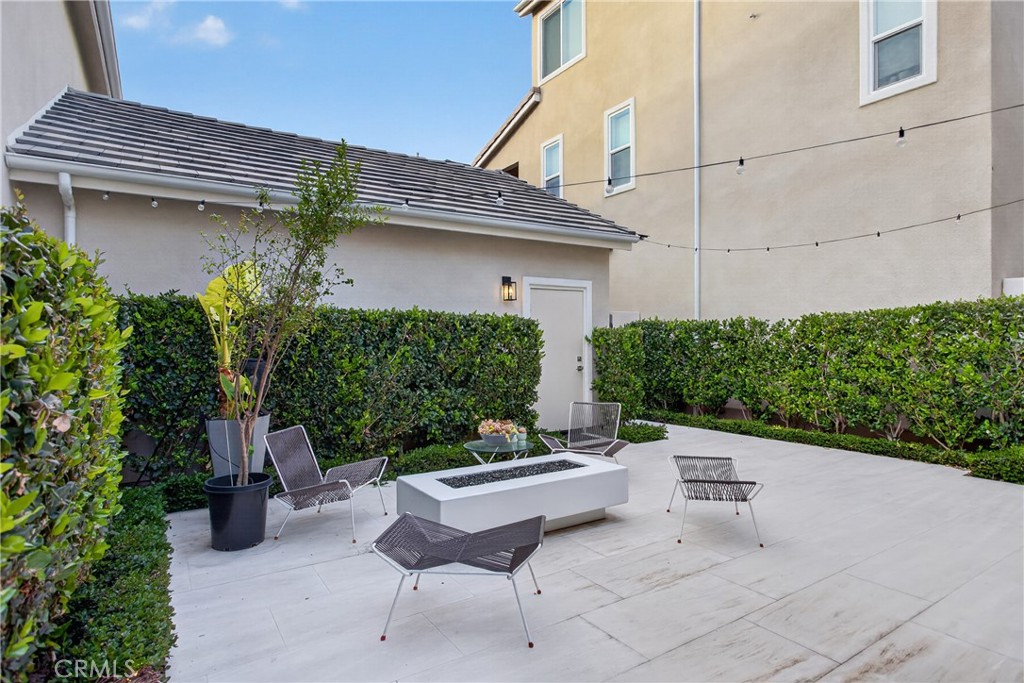 382 Chorus Irvine, CA 92618 - Photo 28 of 38 a view of a patio with table and chairs and potted plants
