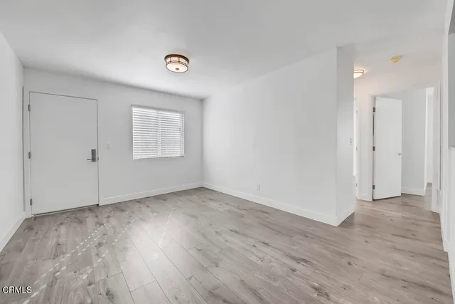a view of a kitchen with wooden floor and a sink